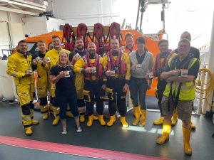 Volunteers from Hastings RNLI with their mugs made by nautiQa.